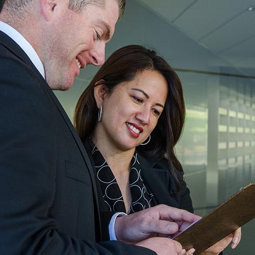 Two healthcare professionals reviewing paperwork together